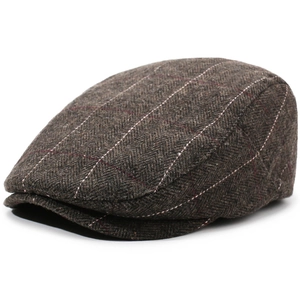 Macro detail of dark grey herringbone wool fabric and red windowpane check on beret