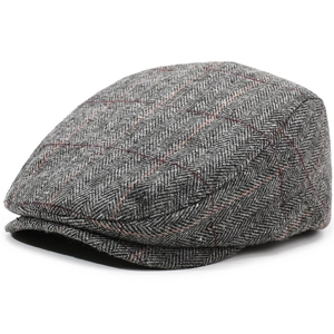 Macro detail of retro herringbone wool fabric with red windowpane check pattern on cap