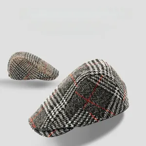 Detail view of plaid newsboy caps with wool texture and precise stereoscopic tailoring