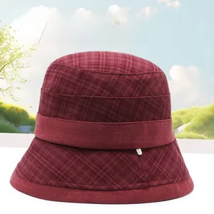 Detail of burgundy checkered bucket hat fabric texture and elegant rolled brim design