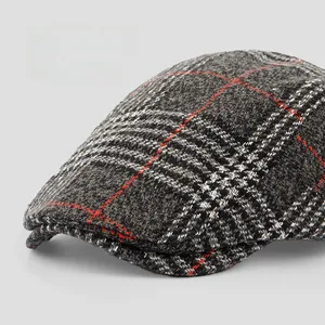 Detail of grey wool plaid flat cap showing thick texture and wide brim for autumn