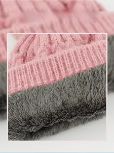Detail of pink knitted winter hat showing thick grey fleece lining for extra warmth