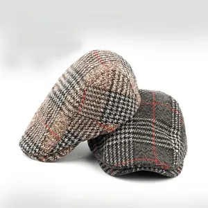 Detailed view of brown and grey plaid wool beret hats with vintage checkered patterns