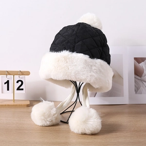 Thick quilted trapper hat for women with faux fur lining and plush pompom details