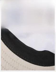 Detail view showing a wide black sweatband and breathable white mesh lining of the sun hat