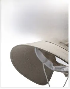 Detailed macro view of the khaki sun hat showing breathable linen texture and logo