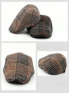 Detail showing vintage plaid wool blend texture and red stitch patterns on beret caps