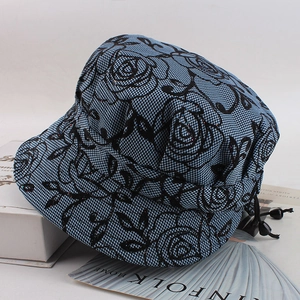 Detail of floral lace mesh and blue plaid fabric on elderly women bucket hat