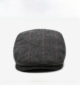 Front view of grey herringbone wool flat cap with vintage red checkered pattern