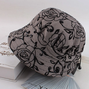 Detail of rose floral lace mesh with houndstooth lining and adjustable drawstring cord