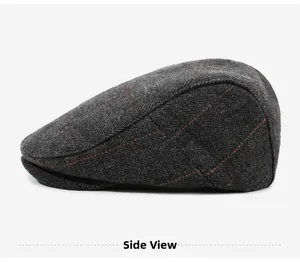 Side view of dark gray herringbone newsboy hat with red windowpane check pattern