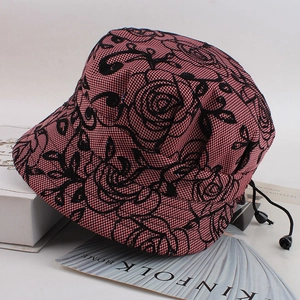 Close-up of pink bucket hat with black floral lace and adjustable drawstring