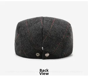 Back view of wool herringbone flat cap featuring red plaid pattern and adjustable metal snap