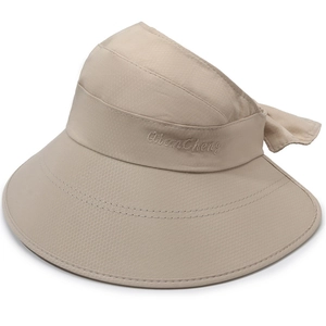 Detail of beige sun hat with honeycomb breathable texture and decorative bow tie