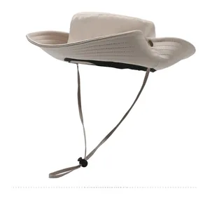 Detail view of beige outdoor sun hat with adjustable windproof drawstring and metal side button