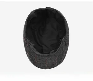 Detail view of the black inner lining and sweatband of this wool plaid flat cap