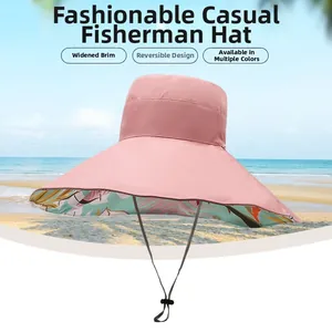 Detail of light pink wide brim sun hat showing tropical palm leaf reversible lining