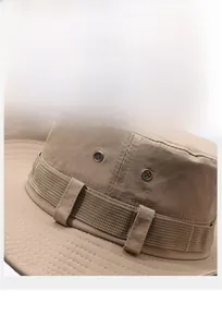 Detail of khaki outdoor sun hat featuring nylon fabric texture and metal ventilation holes