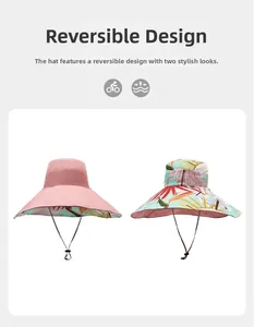 Detail view of double-sided sun hat showing solid pink and tropical floral print patterns