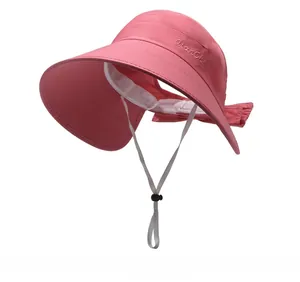 Detailed view of pink sun hat with embroidery, adjustable wind cord, and rear bow accent