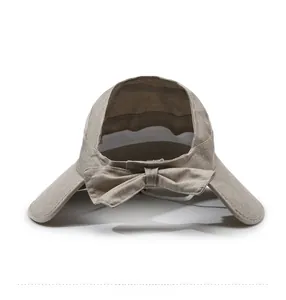 Detail view of khaki sun hat featuring a breathable linen texture and large rear bow