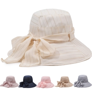Detail view of wide brim sun hat showing textured fabric with elegant bow and color options