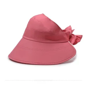 Detailed side view of pink sun hat featuring a large decorative bow and side embroidery