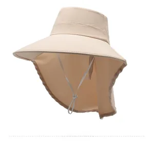 Detail of beige sun hat with wide brim, neck protection flap, and adjustable drawstring