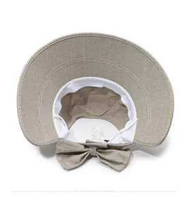 Detail of khaki sun hat featuring adjustable drawstring and breathable inner sweatband