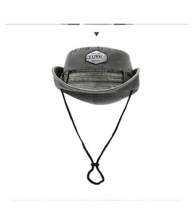Close-up of charcoal grey cotton sun hat with patch embroidery and adjustable chin strap