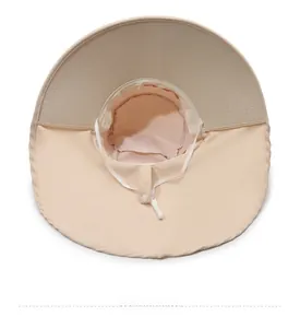 Detail of breathable mesh lining and adjustable strap inside a beige sun protection hat