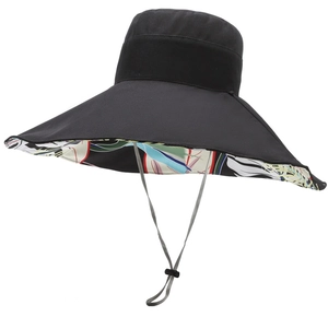 Women's wide brim sun hat with reversible black exterior and tropical floral inner print