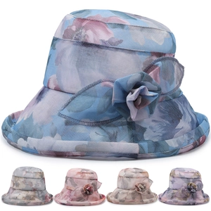 Detail view of chiffon sun hat featuring floral accents in blue, grey, pink, beige and purple