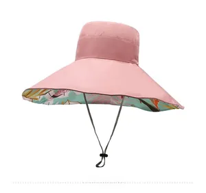 Detail of pink wide brim sun hat with tropical floral print lining and adjustable wind cord