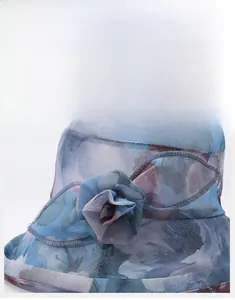Close-up of a blue sun hat featuring intricate 3D chiffon floral ornaments and airy fabric