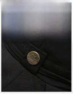 Macro view of textured fabric and antique bronze buckle on a black sun hat