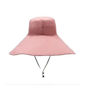 Rear view of a pink wide-brim sun hat for women with an adjustable black chin strap