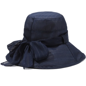 Navy blue wide brim sun hat with oversized bow detail and elegant striped fabric