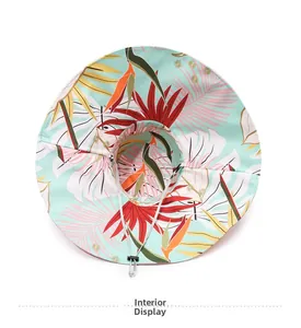 Detail view of the tropical floral print and adjustable drawstring on wide brim sun hat