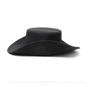 Side view detail of black wide brim outdoor hat with metal snap buttons for sun protection