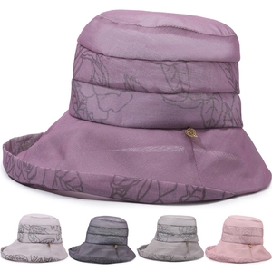 Detail of silk-texture sun hat with rose pattern, gold leaf buckle and multiple color options