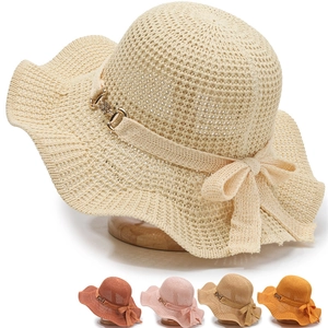 Detail of hollow knit sun hat featuring a bow accent and diverse color selection