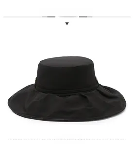 Detailed front view of a breathable black wide-brim sun hat with textured fabric and metal button