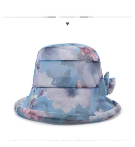 Close-up of blue floral chiffon sun hat with elegant side bow and rolled brim