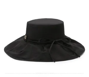 Side view of black sun hat featuring a decorative bow and metallic buckle detail