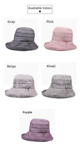 Detail of floral printed sun hats in five colors with golden leaf accents and sheer fabric