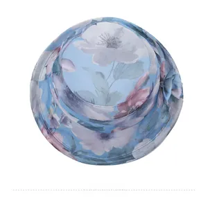 Top view detail of a sky blue sun hat with floral patterns and a side flower decorative accent