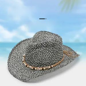 Detail of woven cowboy sun hat featuring natural shells and beads on a brown decorative band
