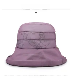 Front view of purple sun hat with vintage rose patterns and pleated fabric detail