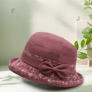 Vue détaillée d'un chapeau cloche bordeaux avec nœud élégant et motifs floraux